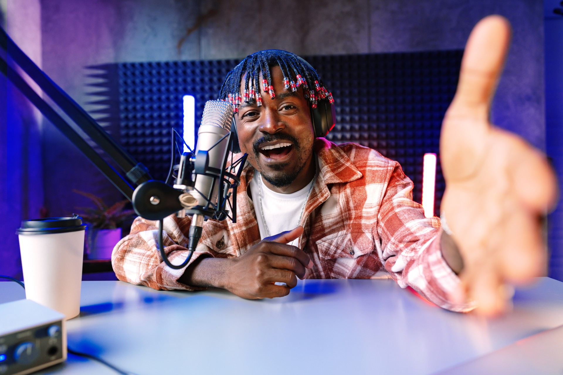 Happy young african man audio blogger broadcasting at studio
